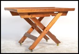 A vintage retro 20th century teak folding butlers metamorphic table on stand / trollet with