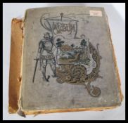 An early 20th century postcard - decoupage album consisting of many cut-outs, cards, christmas casds
