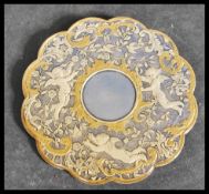 A French brooch, of circular form, the centre decorated with a pensive cherub within a gilt