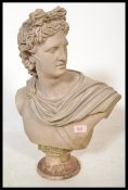 A good composite bust of Apollo raised on a pedestal base with incised name to front. Modeled with