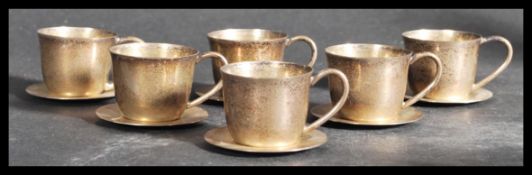 A set of six sterling silver demitasse small coffee cups / cans with matching saucers. Each cup of