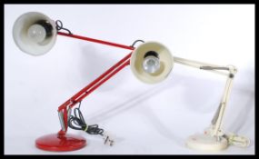 Two vintage retro 20th century anglepoise type desk lamps in red and cream colourways raised on
