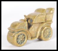A brass cased vesta in the form of a vintage car with no. 32 to side.