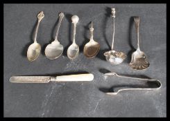 A collection of hallmarked silver flatware to include a pair of sugar tongs Birmingham Charles