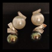 A pair of 18ct white gold south sea pearl drop earrings set with diamonds. Complete in