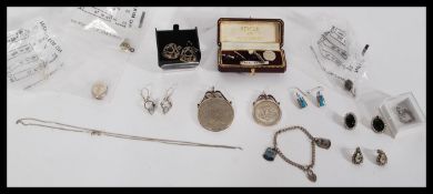 A group of sterling silver jewellery to include earrings , cuff links , pendant , coin pendants ,
