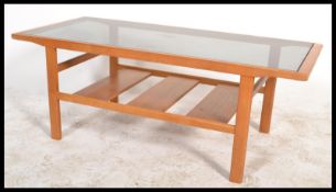 A retro 20th Century Danish inspired long John style coffee table, drop in glass centre, raised on