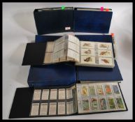 A LARGE collection of assorted vintage cigarette and trade cards. Spanning 8x albums, all neatly