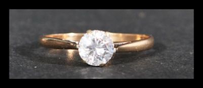 A hallmarked 9ct gold solitaire ring set with a single white stone. Hallmarked Sheffield. Weight 1.