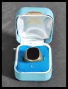 A cased hallmarked 9ct gold gents signet / intaglio ring, set with a unmarked black stone