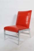 A 1960's retro vintage low easy lounge chair upholstered in a vivid burnt orange vinyl leather