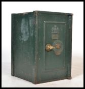 An early 20th century cast iron safe with central door and in original paintwork, The with handle in