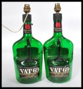 A pair of vintage VAT 69 Whisky bottles having a later conversion to table lamps.