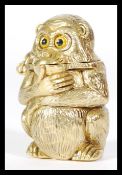 A brass Vesta case in the form of a squat monkey deep in thought, hinged top with strike to base.