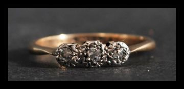 A 9ct gold and platinum 3 stone diamond ring. Marked 9ct Plat, tests 9ct gold and platinum. Weight