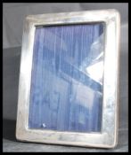 A 20th century silver hallmarked picture frame of rectangular form being easel backed. Hallmarked