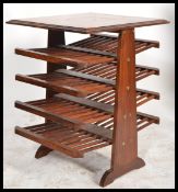 A 20th Century brass inlaid hardwood magazine rack / Canterbury, Having a series of adjustable