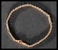 A hallmarked 9ct yellow and white gold fancy link chain bracelet. Import mark for London. Measures