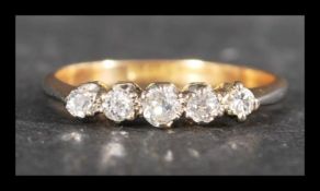 An 18ct gold, platinum and diamond 5 stone ring being set with five old cut diamonds. Diamonds total