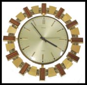 A mid century retro Metamec ' Aztec ' wall clock having silvered dial with baton numerals all within