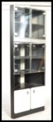 A retro 20th Century corner unit display cabinet, smoked glass doors with fitted white panel