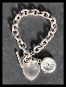 A sterling silver 925 heavy rolo link bracelet chain with large heart bentant and T bar and hood