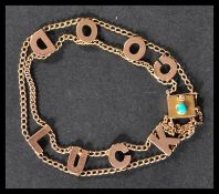 A vintage 9ct gold ' Good Luck'  charm bracelet having a turquoise set clip clasp and safety