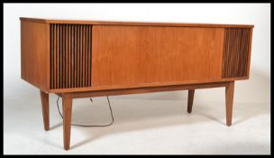 A 1960's teak wood Dynatrom stereogram. The teak case on tapered legs with grill speaker facia.
