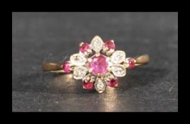 A hallmarked ruby and diamond cluster ring. Hallmarked London. Weight 2g. Size M.5.