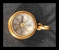 A yellow metal tests as 18ct gold pendant compass of circular form on bale hoop. Weighs 3.8 grams.