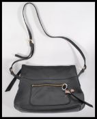 A vintage designer leather handbag hand bag by Radley London having a pink rhinestone Radley dog.