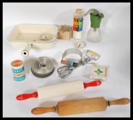 A collection of vintage 20th century kitchenalia kitchen items to include rolling pins , poaching