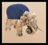 A sterling silver pincushion in the form of an elephant in the manner of Adie and Lovekin. Weighs