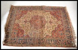 A late 19th Century early 20th Century floor rug of Persian design, central fauna motif design beige