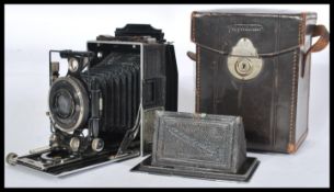 A vintage early 20th Century folding Voightlander bellows camera, in original leather case with
