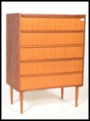 A vintage 1970's teak wood 5 drawer chest of drawers with lip edge drawer handle, rase on atomic