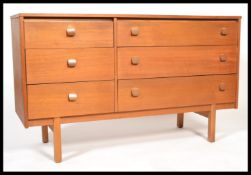 A 1970's retro vintage teak wood six drawer sideboard unit comprising of three narrow flanked by a