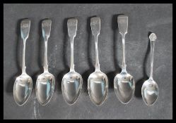 A group of six silver hallmarked spoons to include a set of three Georgian table spoons fiddle