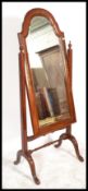 A 20th Century hardwood and brass inlaid cheval mirror of large proportions.  The bevelled glass