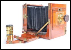 A 19th / 20th Century mahogany and brass plate camera with a brass Rapid Aplanat No. 2 Lens by R.O.