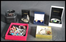 A collection of vintage costume jewellery to include pandora style bracelets , enamel cuff links ,