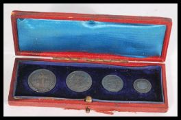 A set of  early 20th century 1902 Maundy coins. The four piece coin set in a fitted case. Largest