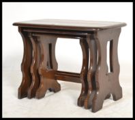 An Ercol elm wood Old Colonnial style nest of tabl