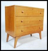 A mid century retro walnut chest of drawers in the