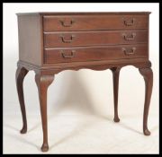 An early 20th century Canteen of cutlery on legs. The mahogany case raised on cabroile legs with