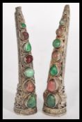 Two Chinese silver finger guard brooches set with a line of semi precious stones.