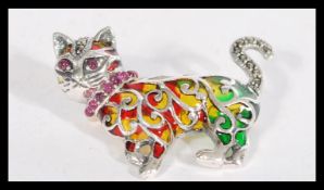 A sterling silver and marcasite plique a jour brooch in the form of a cat.
