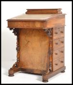 A 19th century VIctorian mahogany inlaid davenport desk. The hinged top with tooled leather