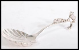 A silver hallmarked caddy spoon having shell bowl