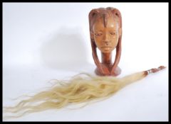 A vintage African carved tribal bust of a lady alo